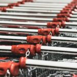 Empty shopping carts at grocery store - save money on groceries